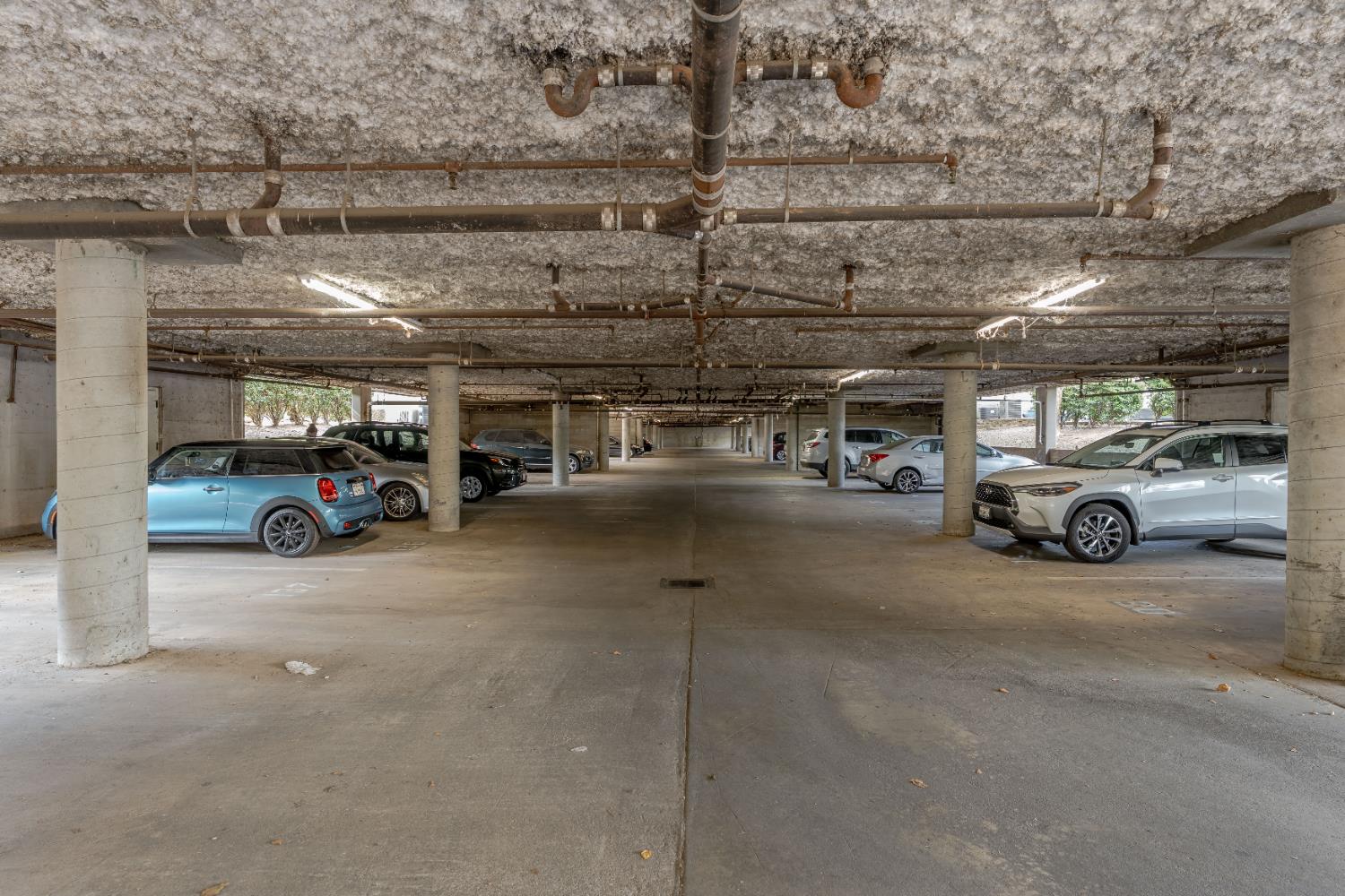 1019 Dornajo Way, Unit 123 Sacramento, CA 95825 - Photo 5 of 23 a view of parking garage with cars