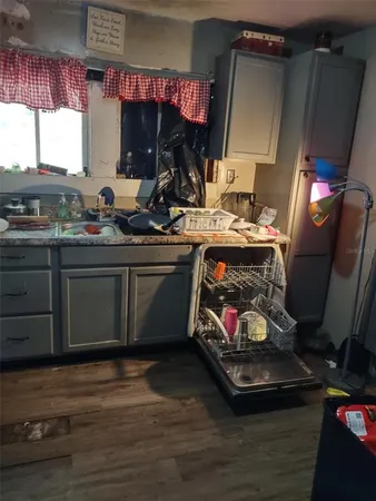 a kitchen with sink refrigerator and window