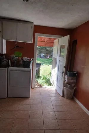 a kitchen with a refrigerator and a stove
