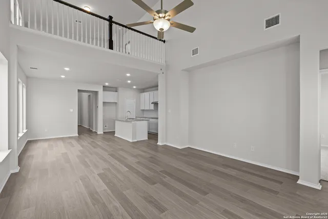 a view of a kitchen with a sink and a refrigerator