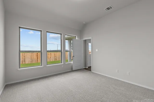 an empty room with a empty space and windows