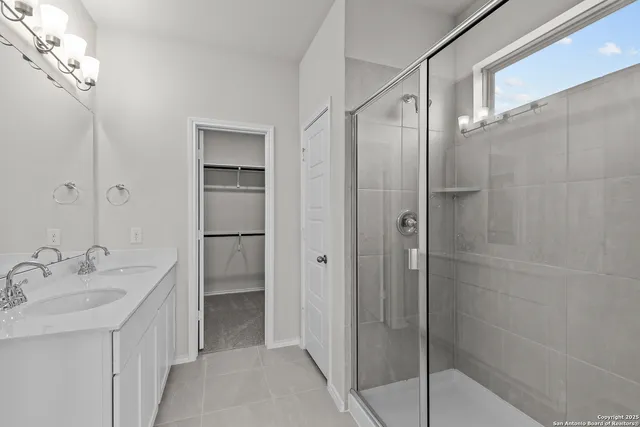 a bathroom with a shower sink and mirror