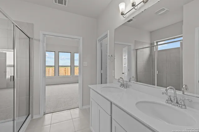 a bathroom with a double vanity sink and a mirror