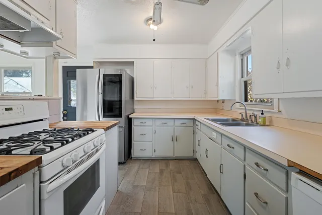 a kitchen with sink stove and cabinets