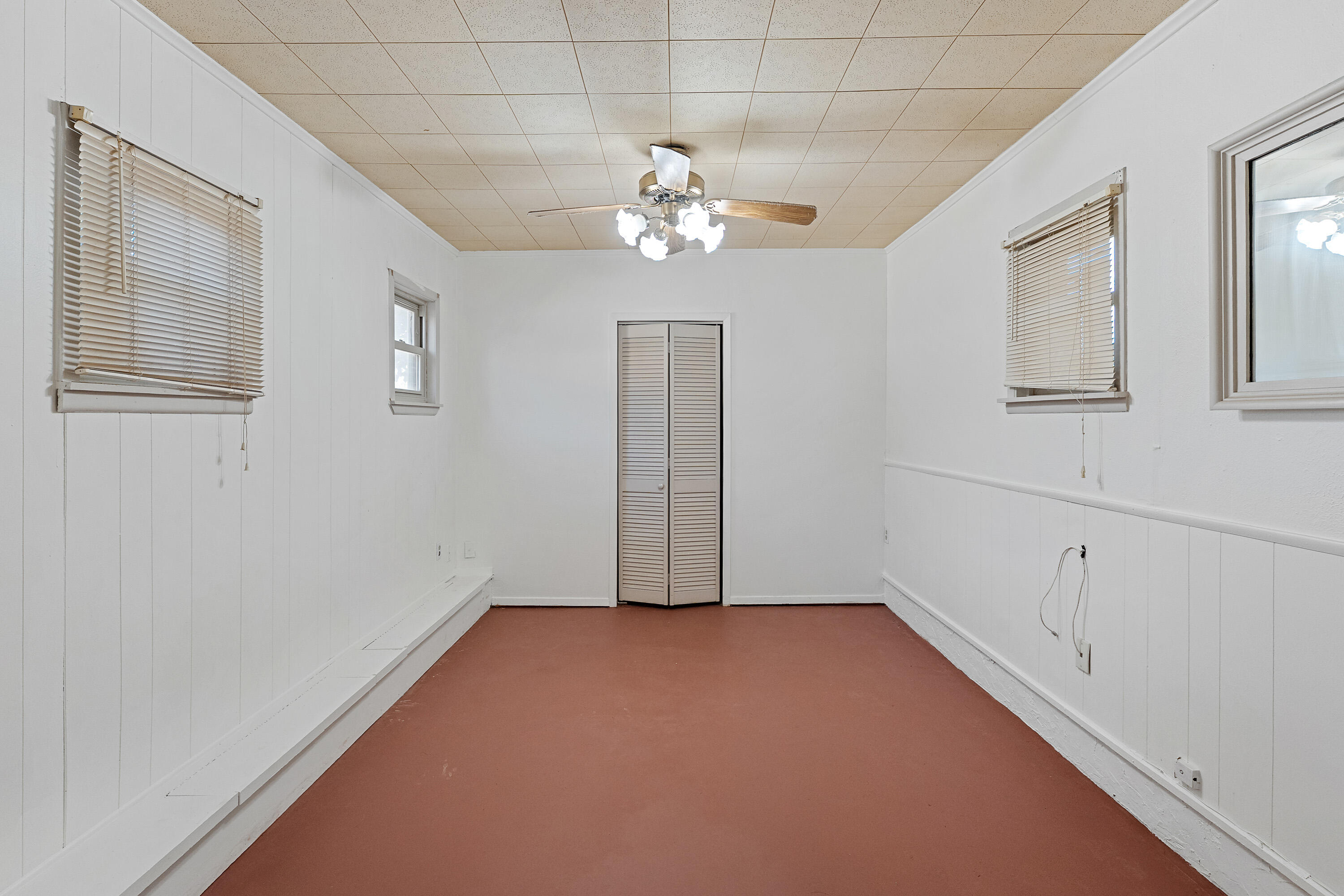 705 6th Street Wolfforth, TX 79382 - Photo 16 of 29 an empty room with chandelier fan and windows