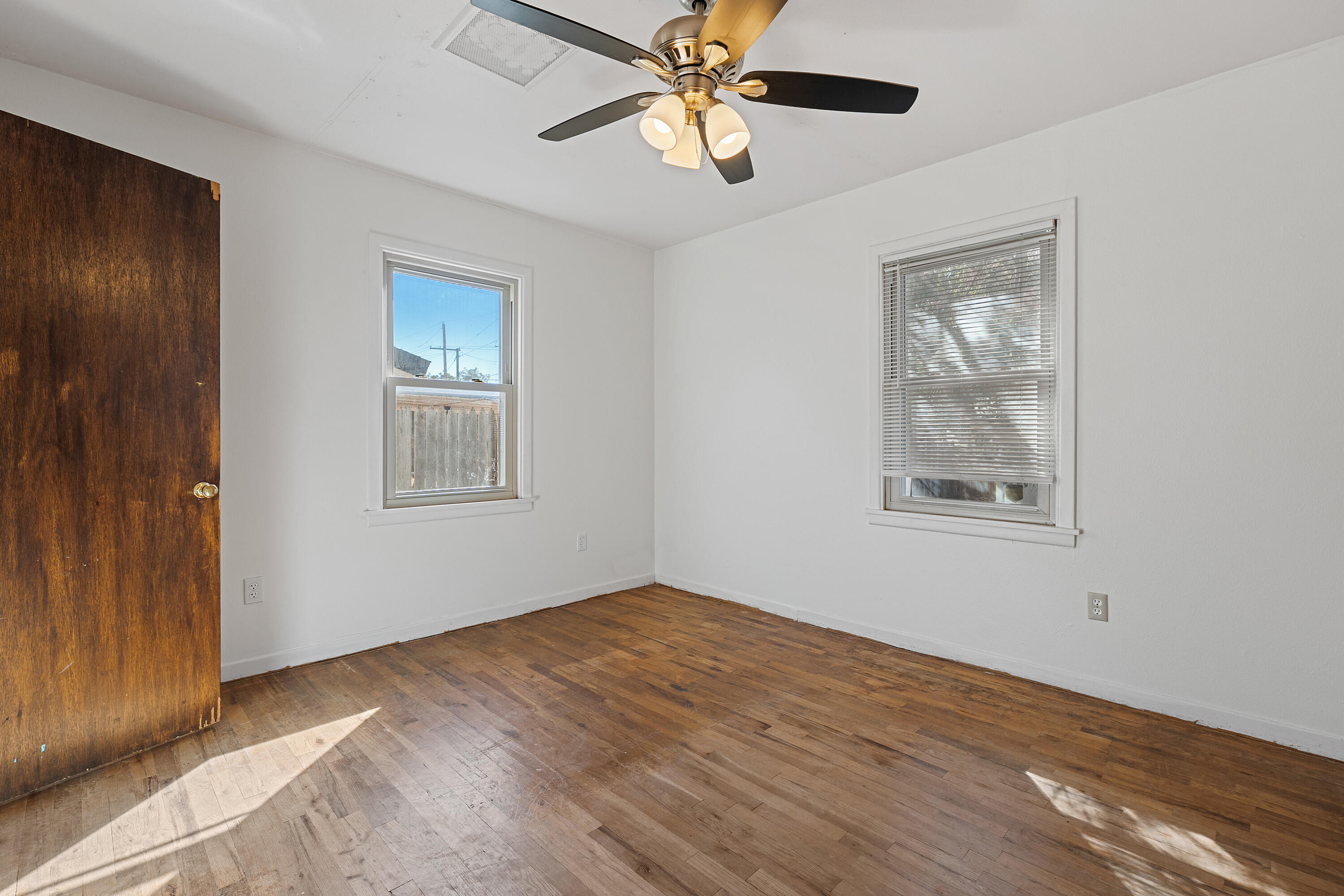 705 6th Street Wolfforth, TX 79382 - Photo 18 of 29 a view of an empty room with window and wooden floor