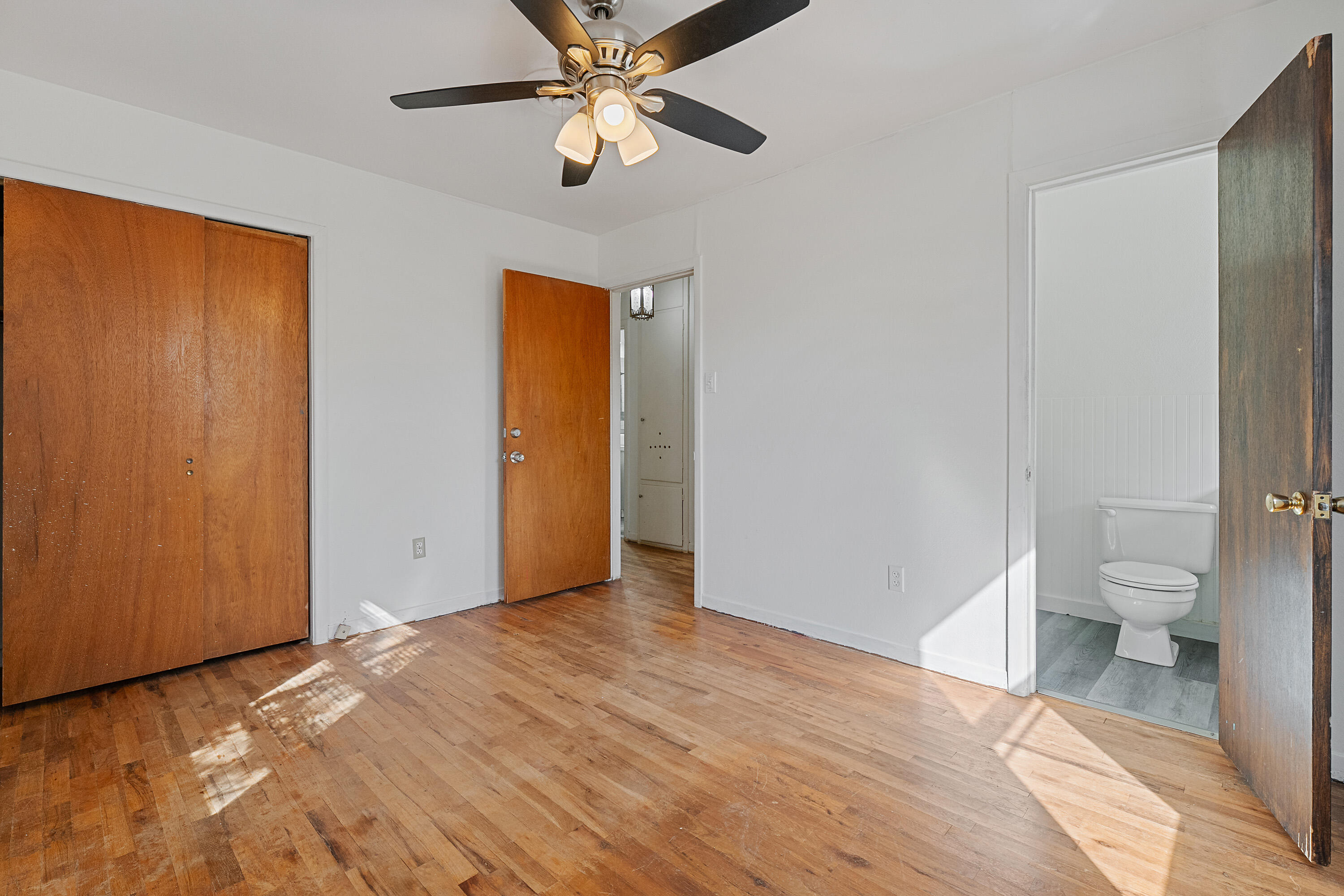 705 6th Street Wolfforth, TX 79382 - Photo 19 of 29 a view of a bathroom with a toilet and a ceiling fan