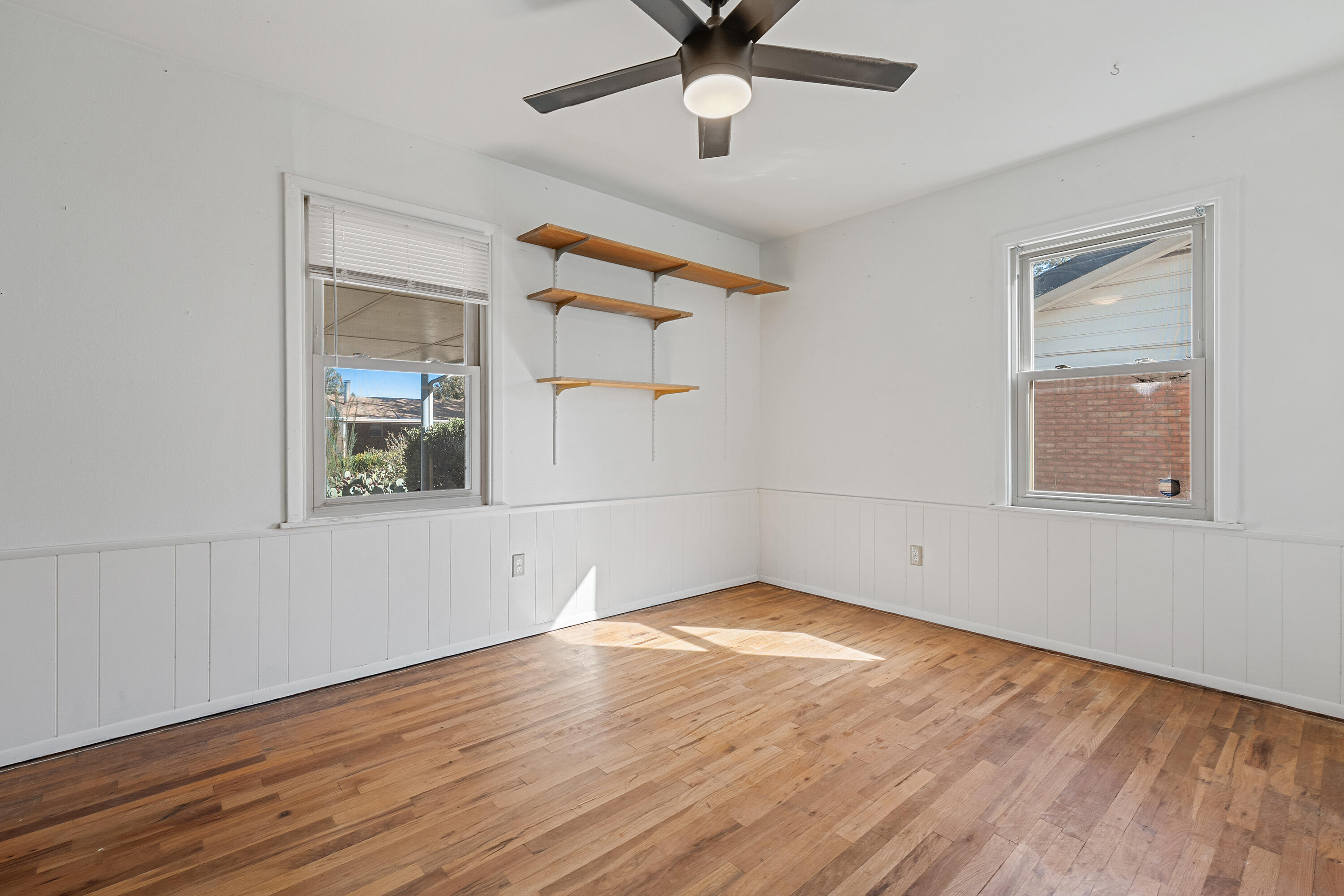 705 6th Street Wolfforth, TX 79382 - Photo 22 of 29 a view of empty room with wooden floor and fan