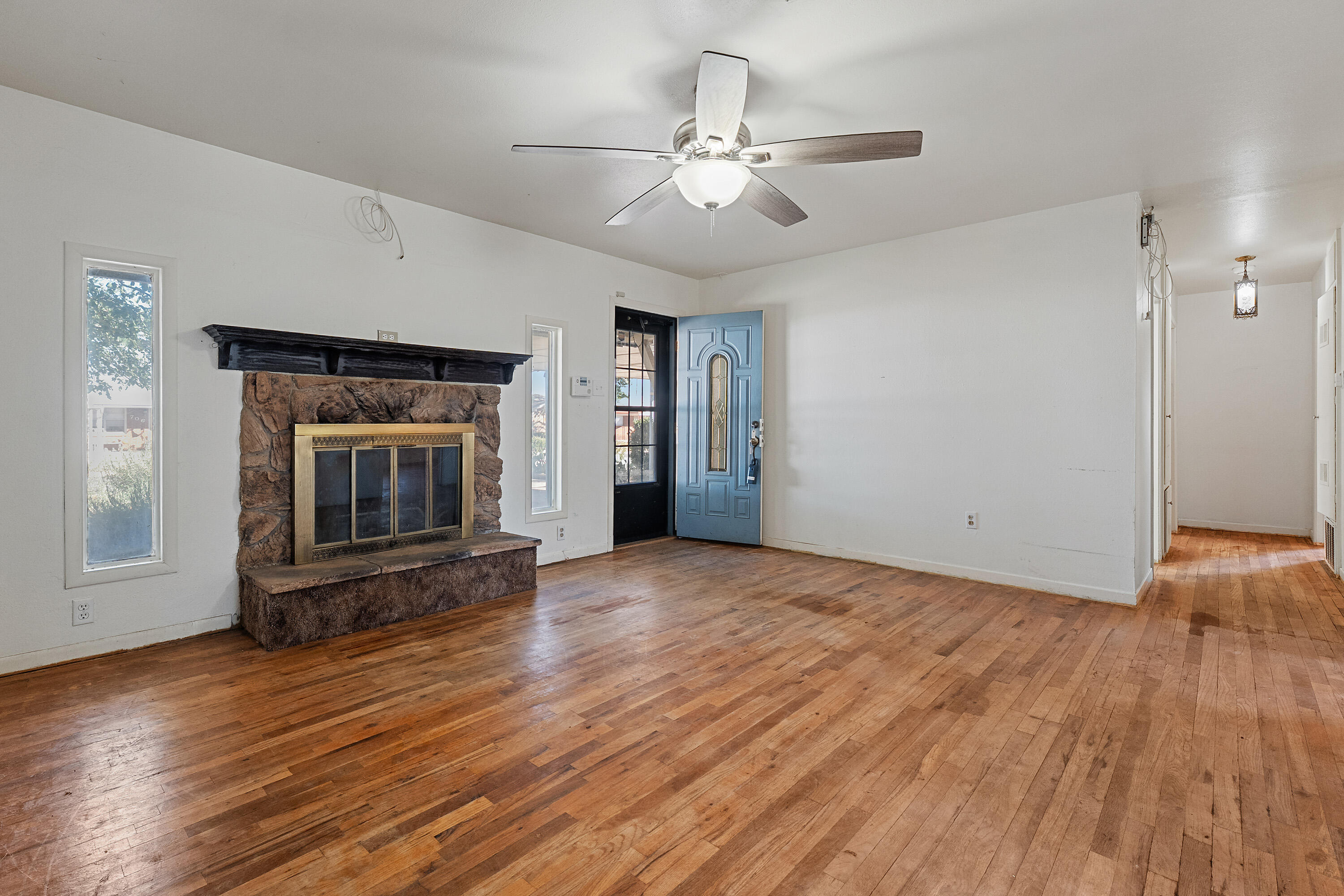 705 6th Street Wolfforth, TX 79382 - Photo 4 of 29 a view of an empty room with wooden floor fireplace and a window