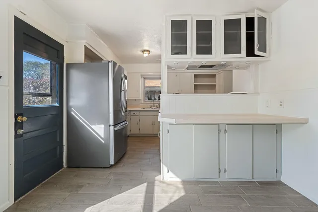a kitchen with stainless steel appliances a refrigerator and a stove