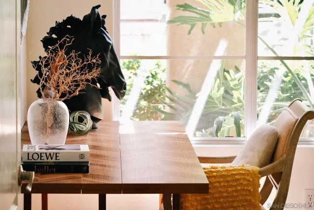 a view of a dining area with furniture and a potted plant