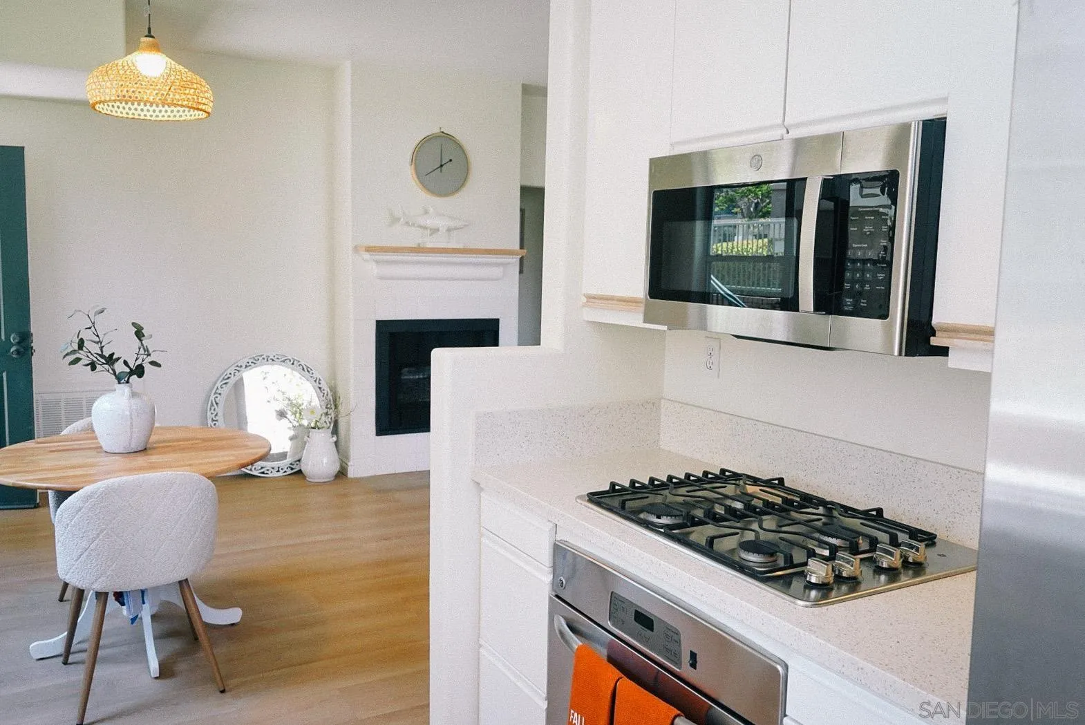 3537 Caminito El Rincon, Unit 259 San Diego, CA 92130 - Photo 21 of 59 a kitchen with stainless steel appliances a stove a table and chairs