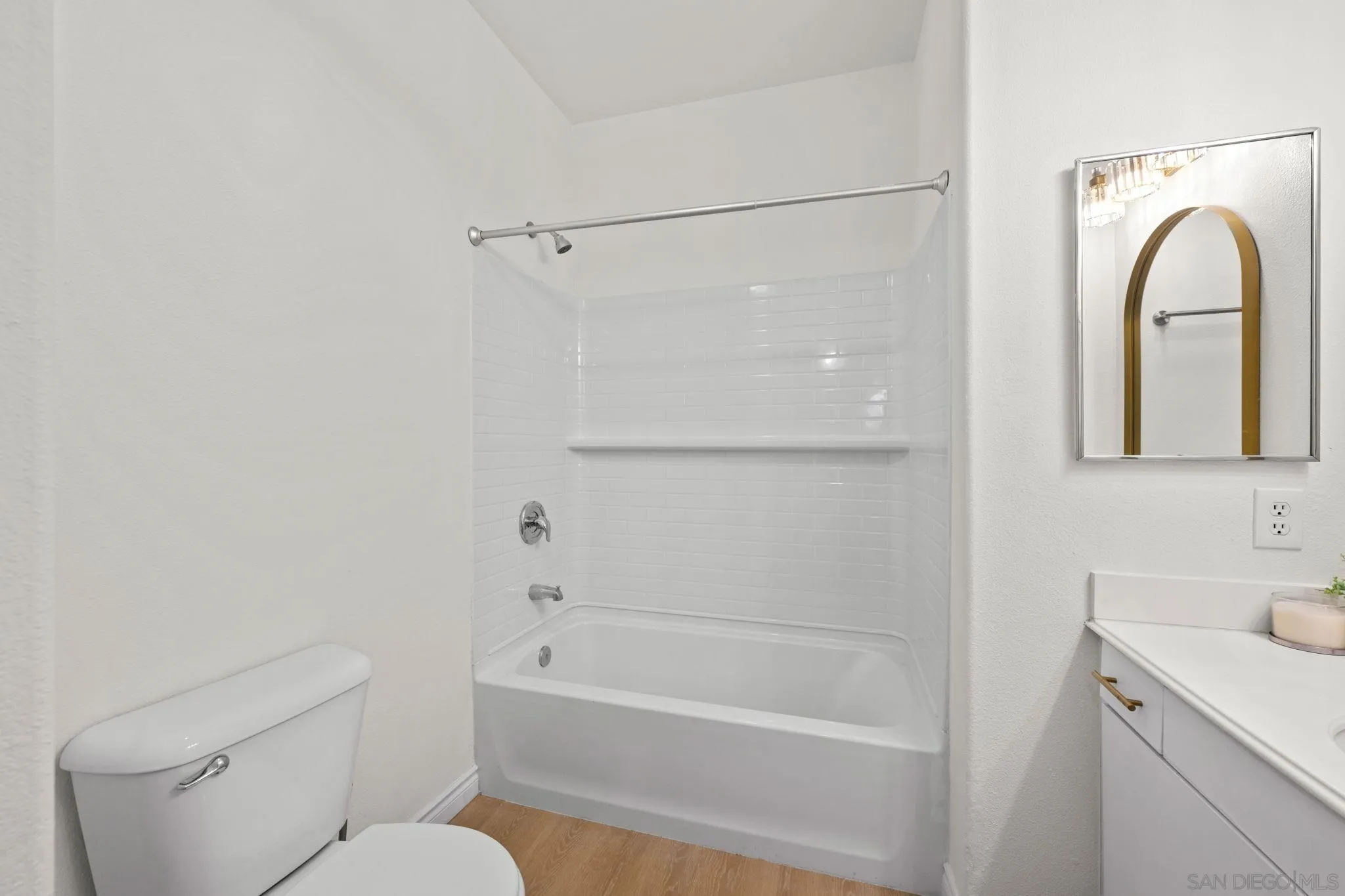 3537 Caminito El Rincon, Unit 259 San Diego, CA 92130 - Photo 26 of 59 a bathroom with a sink a mirror toilet and bathtub