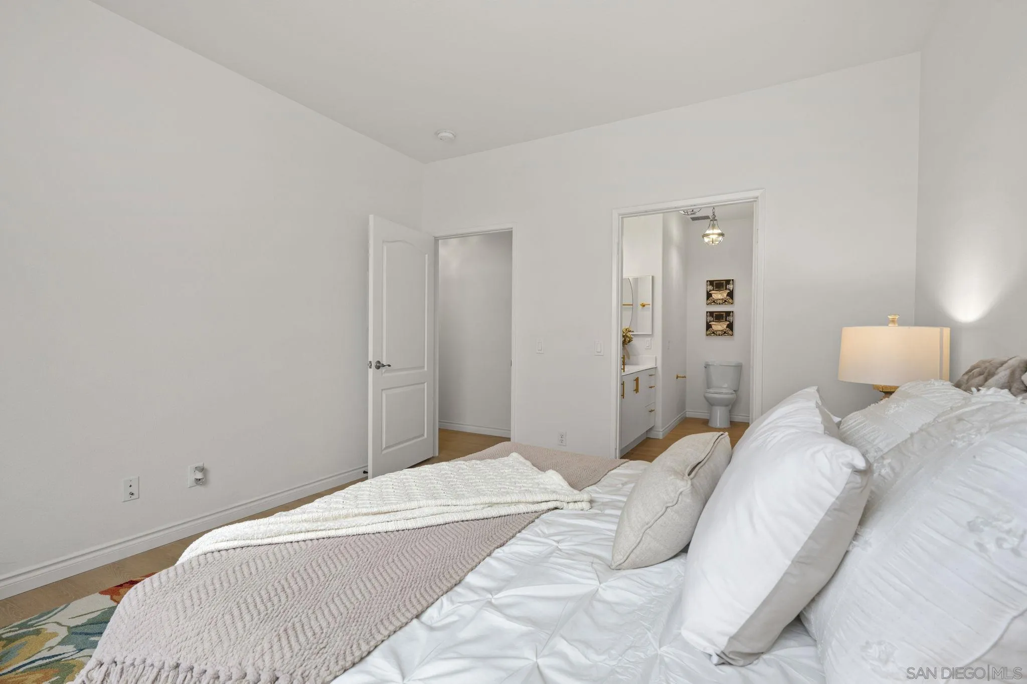 3537 Caminito El Rincon, Unit 259 San Diego, CA 92130 - Photo 30 of 59 a bedroom with a bed and lamp