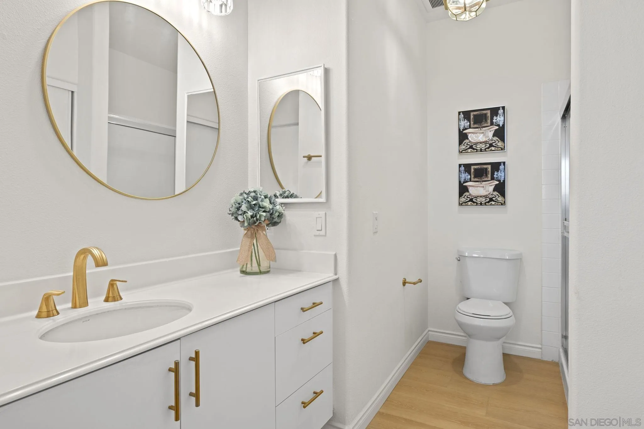 3537 Caminito El Rincon, Unit 259 San Diego, CA 92130 - Photo 31 of 59 a bathroom with a toilet sink and mirror