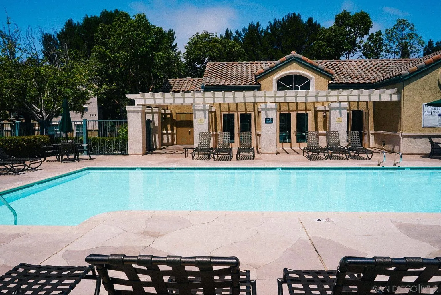 3537 Caminito El Rincon, Unit 259 San Diego, CA 92130 - Photo 38 of 59 a front view of a house with garden and sitting area