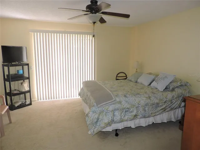 a bedroom with a bed dresser and a window