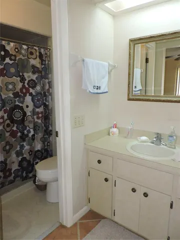 a bathroom with a granite countertop sink mirror and a