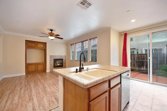 a kitchen with stainless steel appliances granite countertop a refrigerator stove microwave and sink