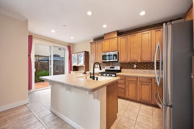a kitchen with a sink appliances and cabinets