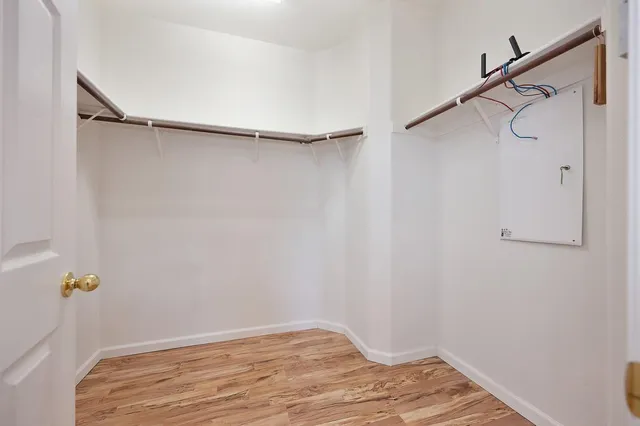 a view of an empty room with wooden floor