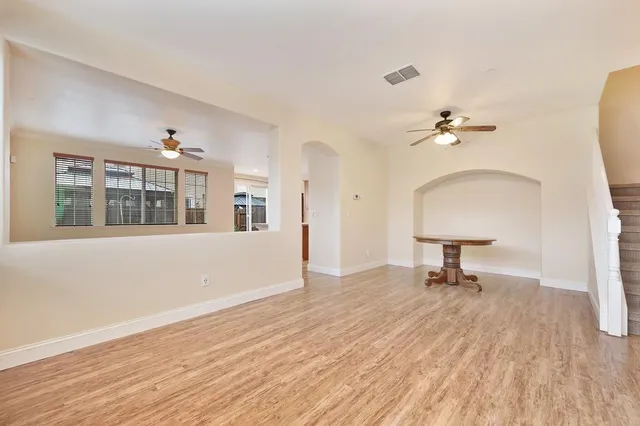 a view of an empty room and a gallery with wooden floor