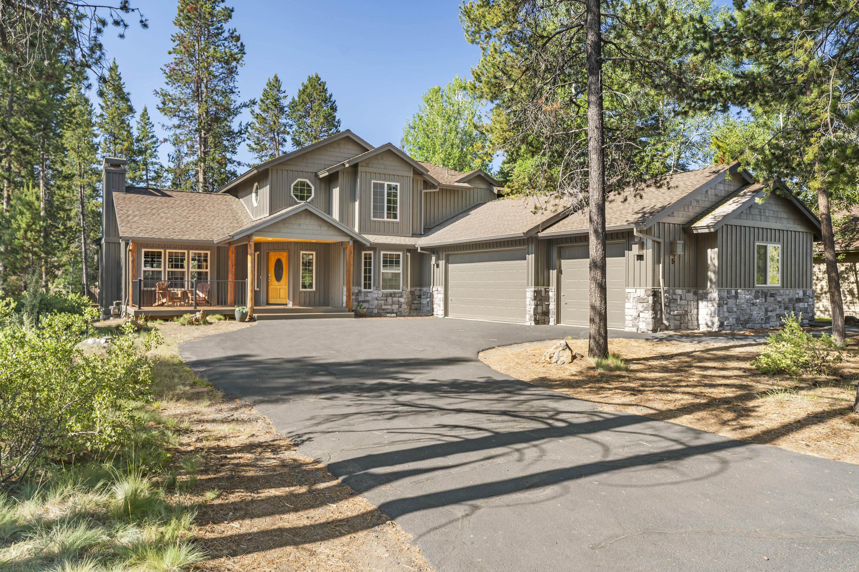 18189 Oregon Loop, Unit 5 Sunriver, OR 97707 - Photo 1 of 41 This beautifully crafted mountain home features a spacious three-car garage, a charming covered porch, and is nestled among tall pines for a serene forest setting.