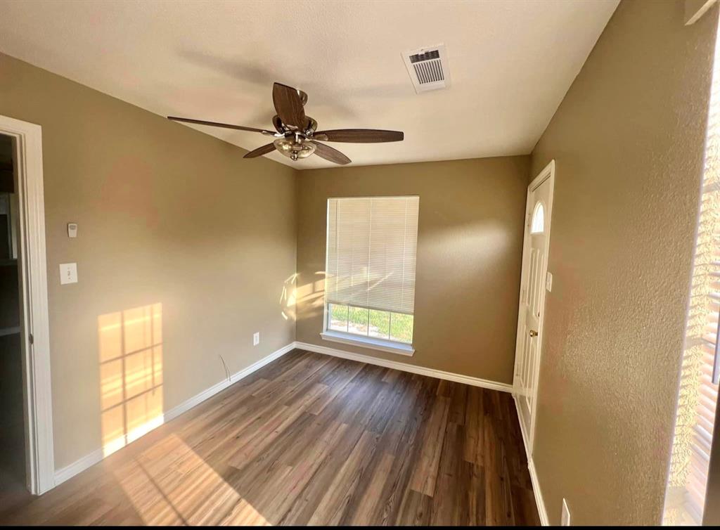 3133 Tbd County Road Lone Oak, TX 75453 - Photo 20 of 21 Warmly toned interior with wood-finish flooring, a ceiling fan, and window with blinds