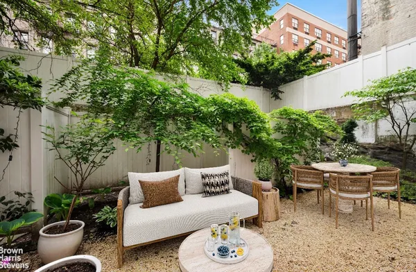 a view of a patio with couches and potted plants