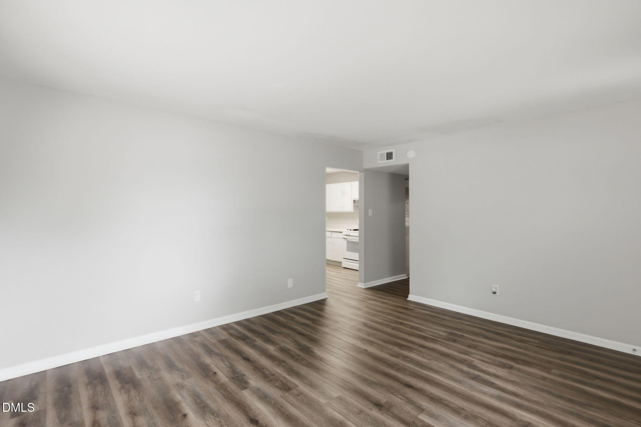 613 Juno Court Raleigh, NC 27610 - Photo 7 of 29 a view of an empty room and wooden floor