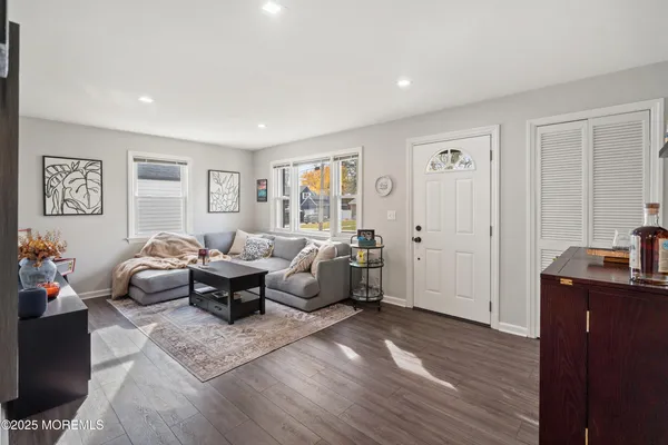 a living room with furniture window and wooden floor