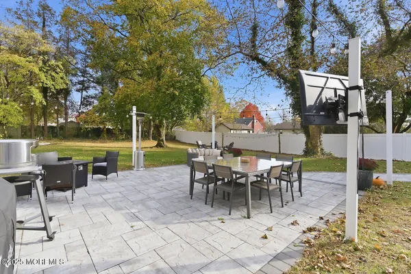a view of a patio with a table and chairs
