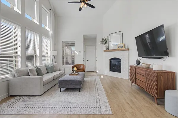 a living room with furniture flat screen tv and a fireplace