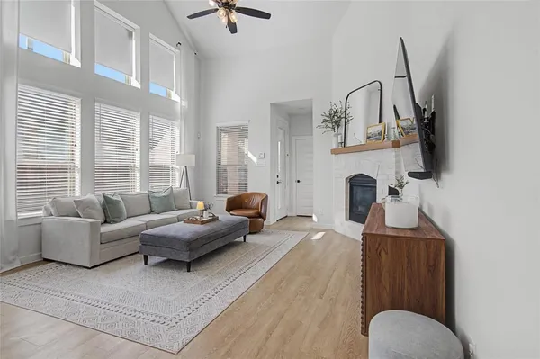 a living room with furniture a fireplace and a flat screen tv