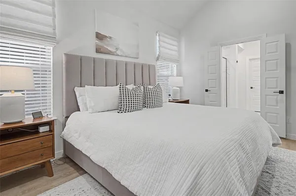 a bedroom with a bed and a window