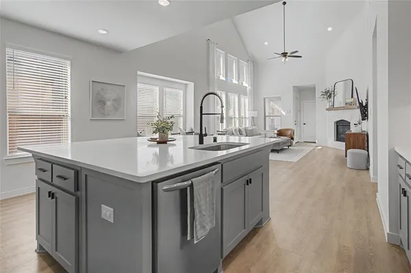 a kitchen with granite countertop a sink stainless steel appliances and cabinets