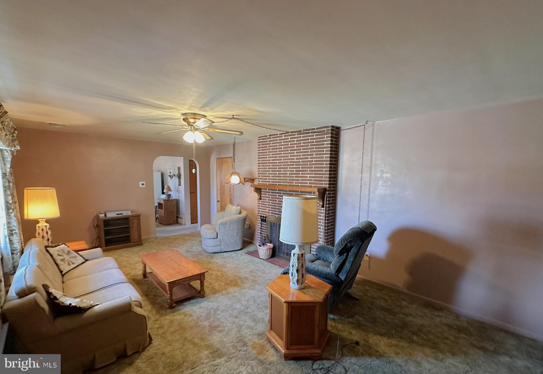 7 Glendale Street Hanover, PA 17331 - Photo 7 of 38 a living room with furniture a fireplace and a chandelier