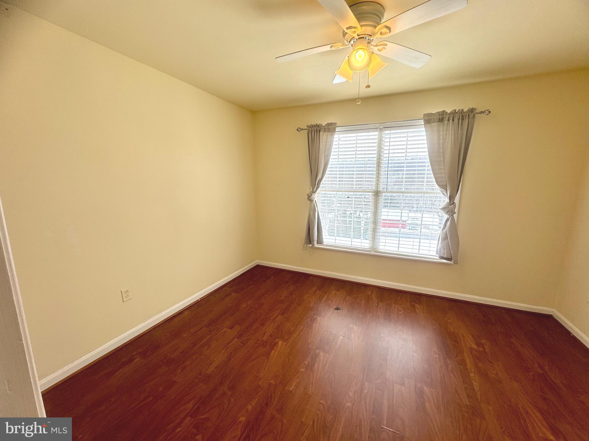 14410 Stottlemyer Road Smithsburg, MD 21783 - Photo 18 of 24 an empty room with wooden floor fan and windows