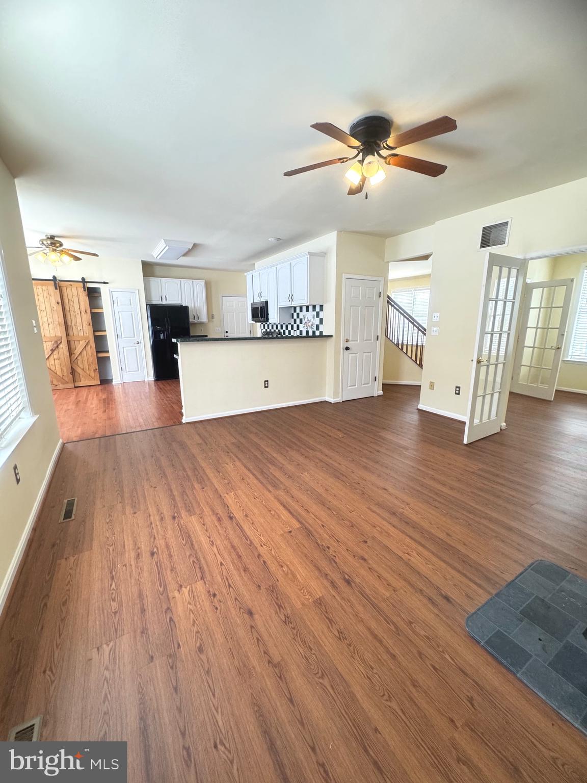 14410 Stottlemyer Road Smithsburg, MD 21783 - Photo 8 of 24 a view of a kitchen with wooden floor and a ceiling fan