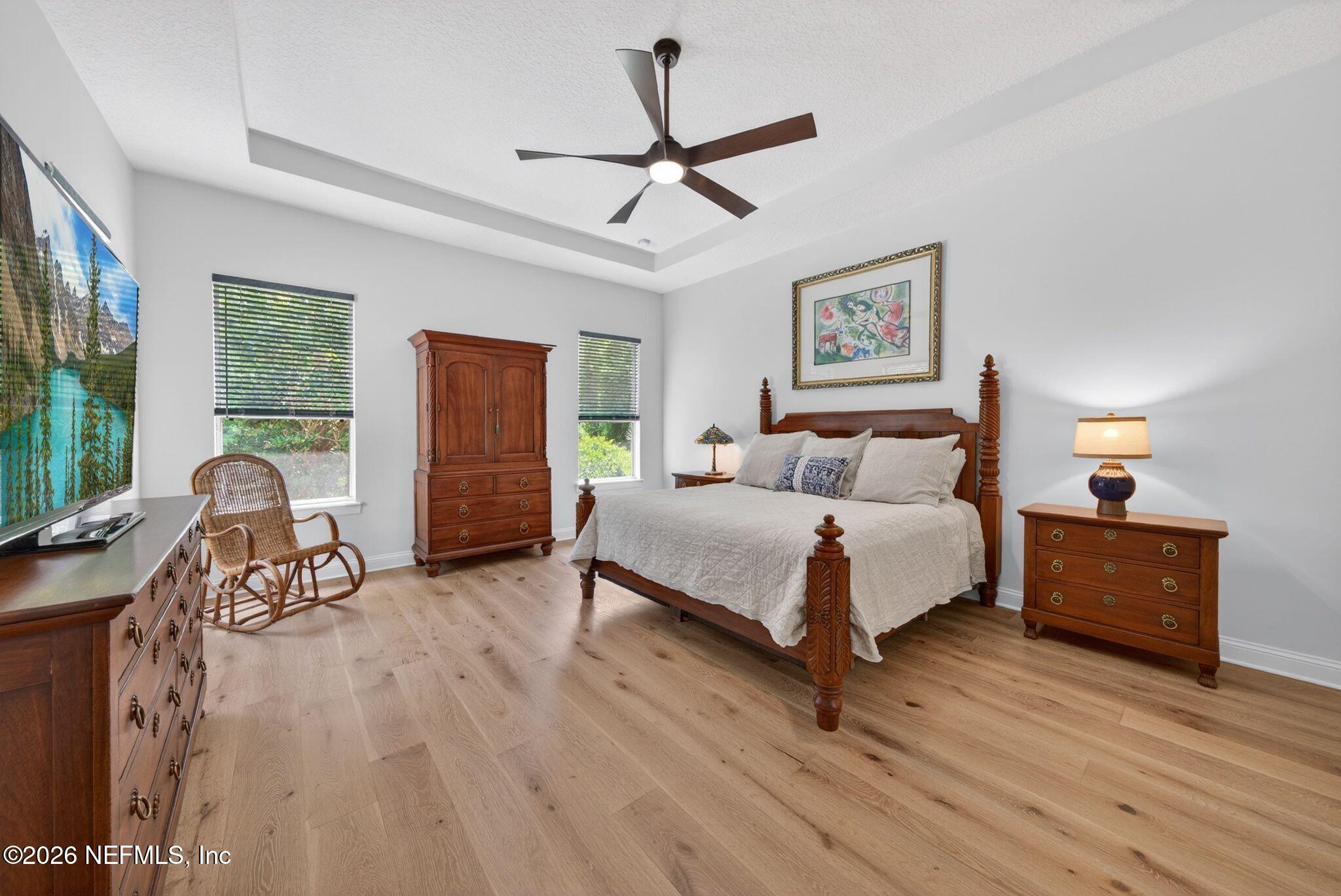 508 Sebastian Square St. Augustine, FL 32095 - Photo 22 of 76 a spacious bedroom with a bed a couch and a large window