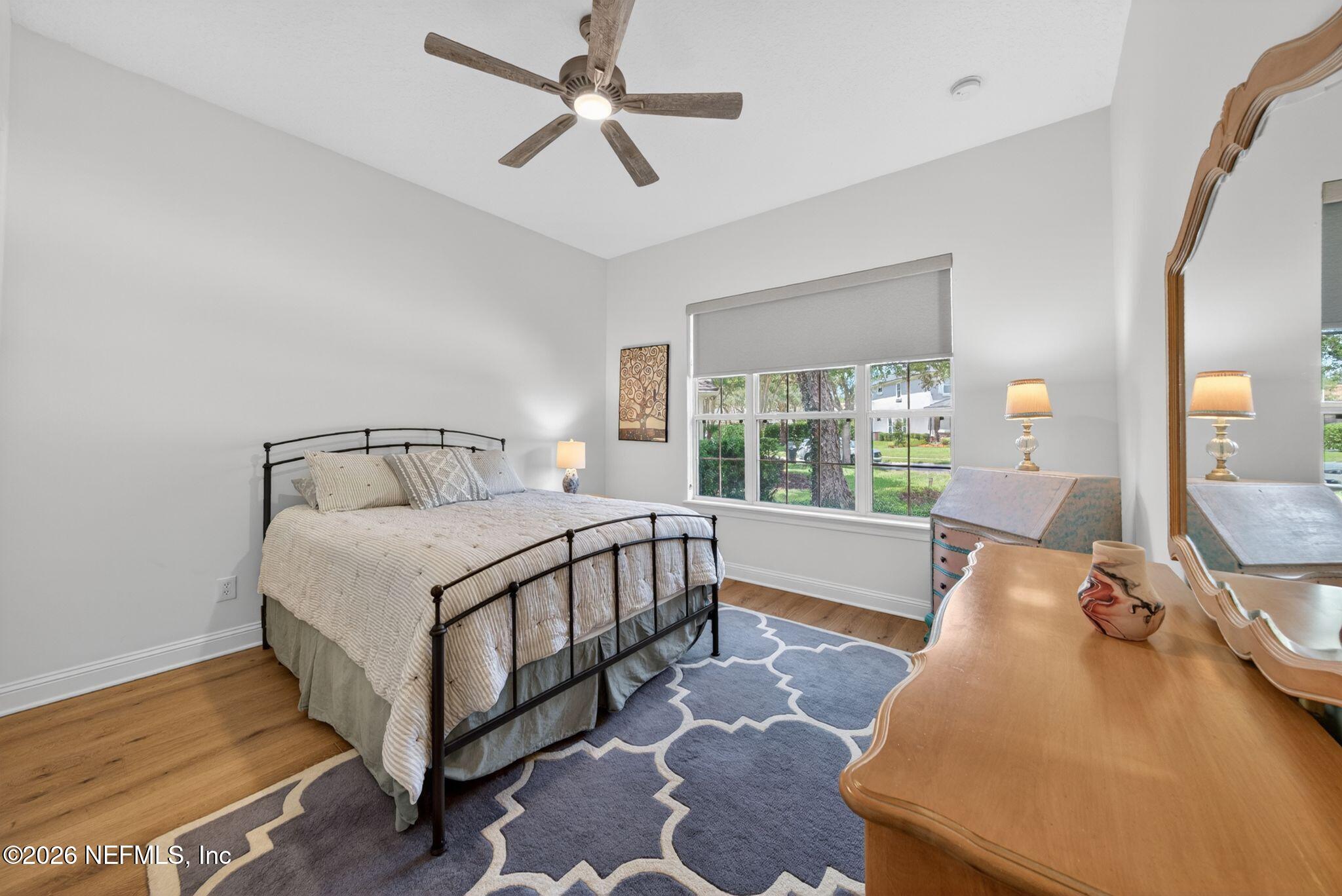 508 Sebastian Square St. Augustine, FL 32095 - Photo 27 of 76 a bedroom with a bed a window and a chandelier