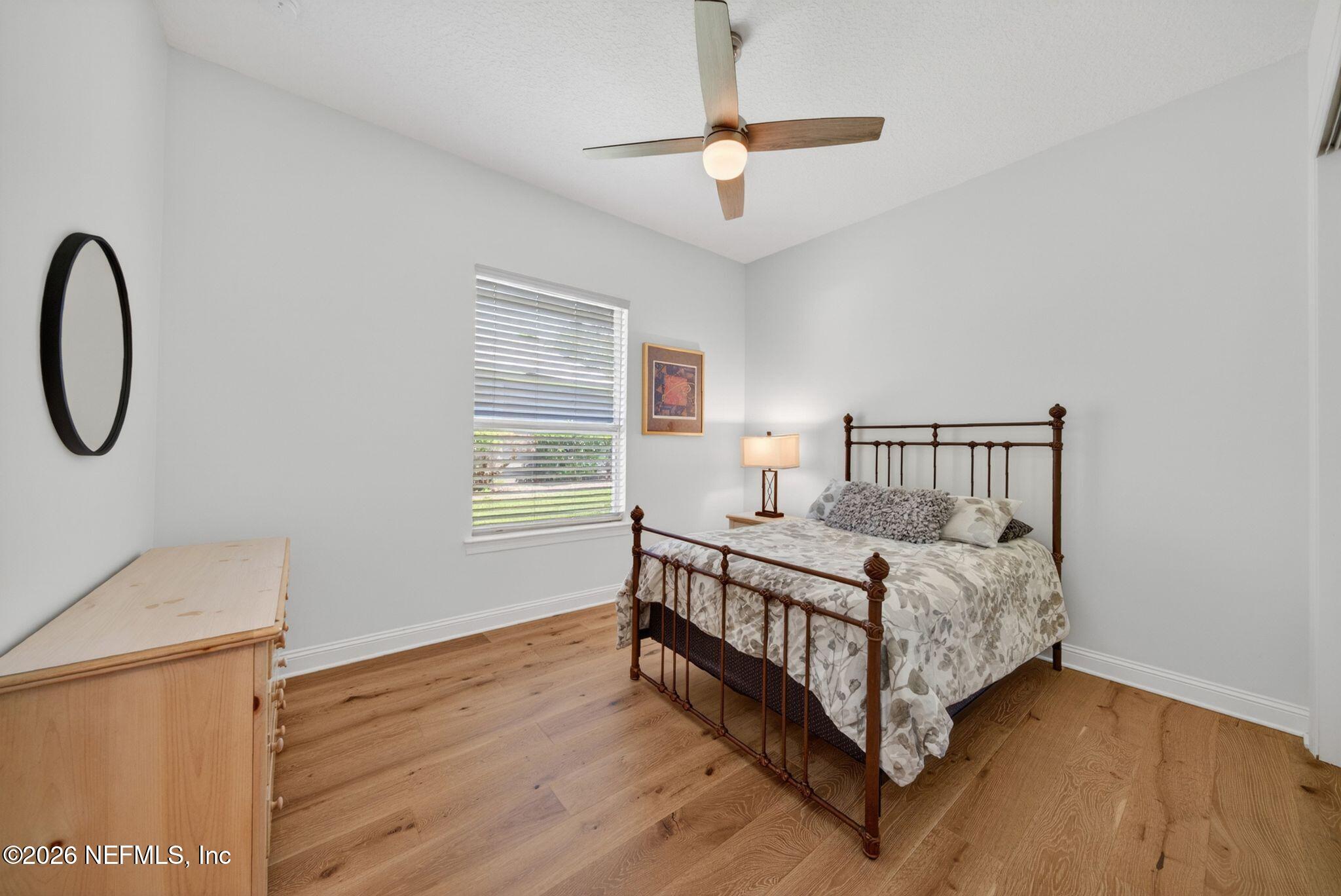 508 Sebastian Square St. Augustine, FL 32095 - Photo 35 of 76 a bedroom with a bed chandelier and a window