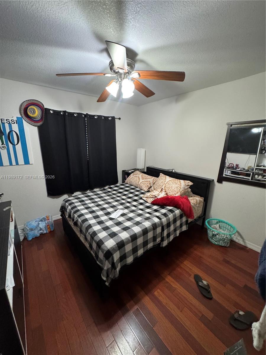 7632 Northwest 166th Terrace Hialeah, FL 33015 - Photo 11 of 20 a bedroom with a bed and wooden floor