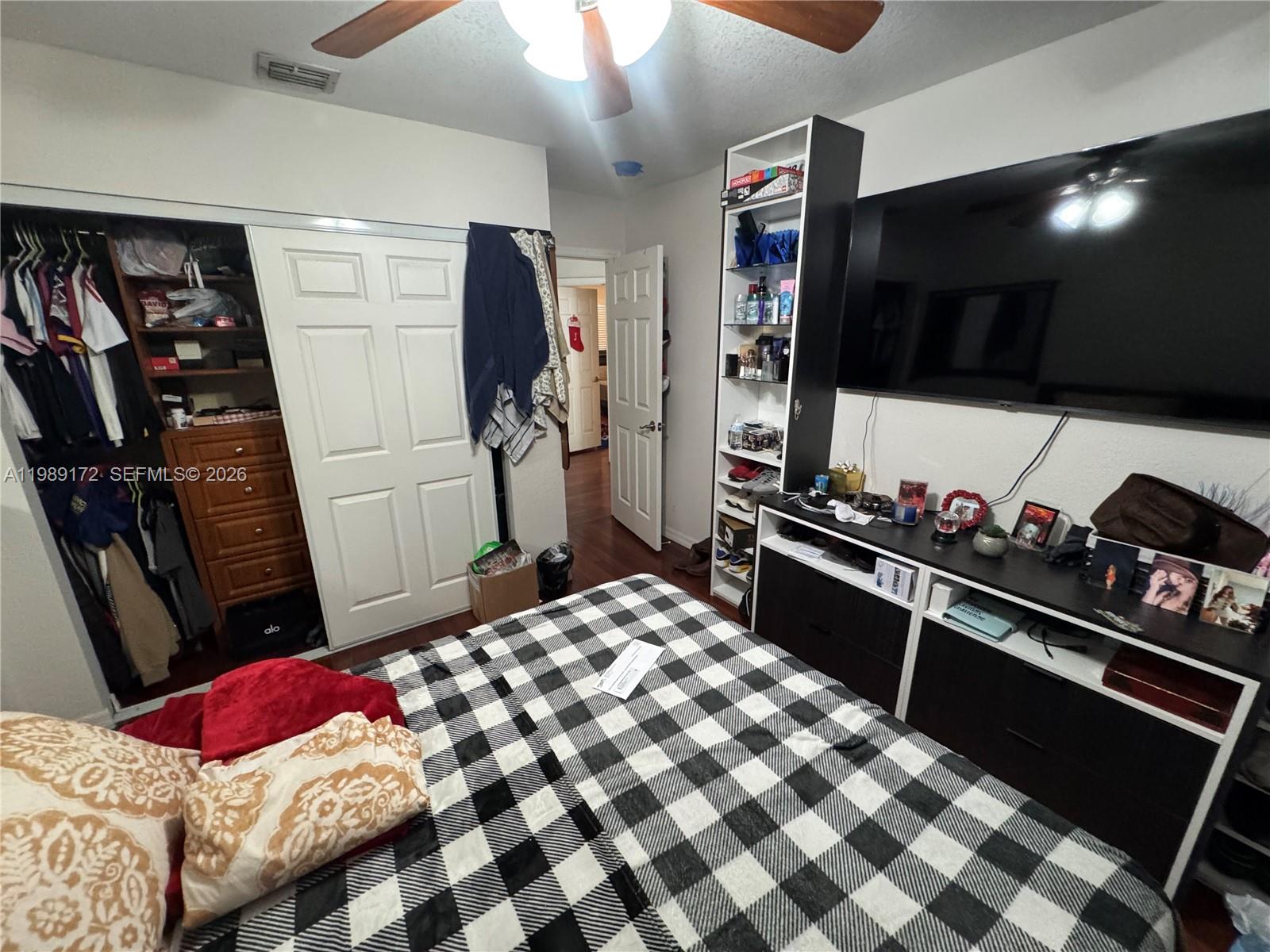 7632 Northwest 166th Terrace Hialeah, FL 33015 - Photo 12 of 20 a bedroom with a bed and a flat screen tv