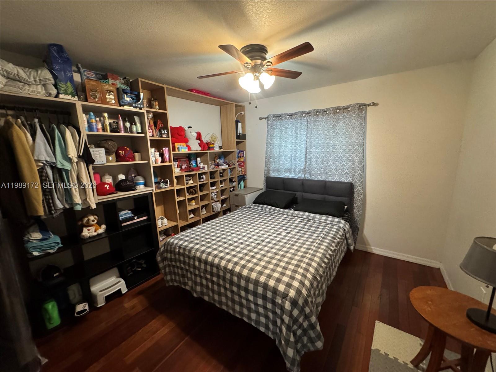 7632 Northwest 166th Terrace Hialeah, FL 33015 - Photo 13 of 20 a bedroom with a bed a baby shelf and a closet