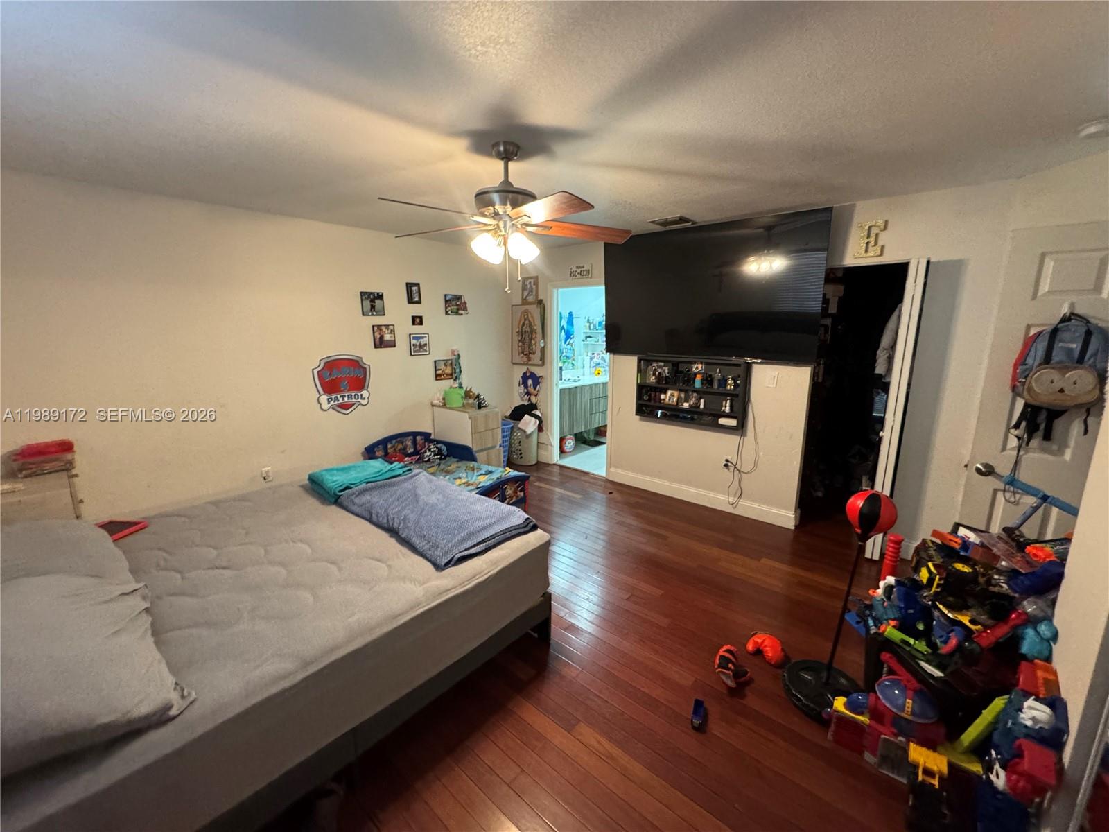 7632 Northwest 166th Terrace Hialeah, FL 33015 - Photo 15 of 20 a living room with furniture gym equipment and a flat screen tv