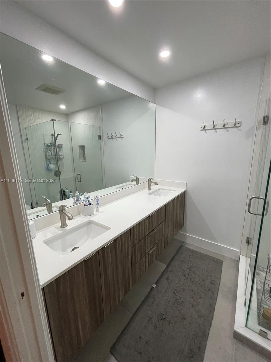 7632 Northwest 166th Terrace Hialeah, FL 33015 - Photo 16 of 20 a spacious bathroom with double vanity and mirrors