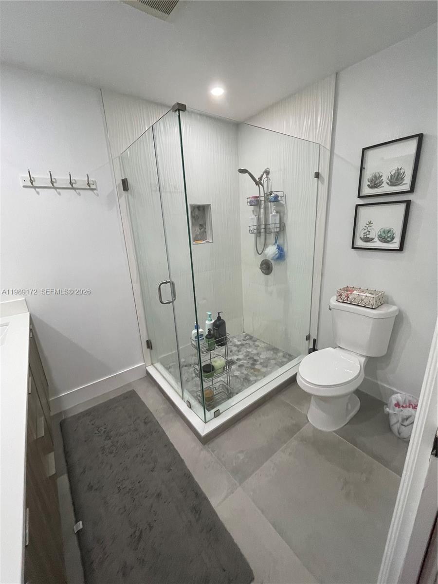 7632 Northwest 166th Terrace Hialeah, FL 33015 - Photo 17 of 20 a bathroom with a sink a toilet and a shower