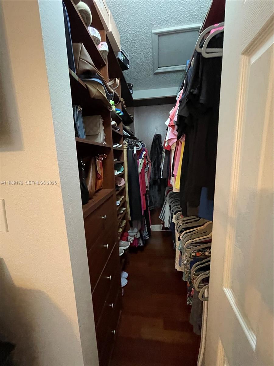 7632 Northwest 166th Terrace Hialeah, FL 33015 - Photo 18 of 20 a view of walk in closet with clothes and shoes