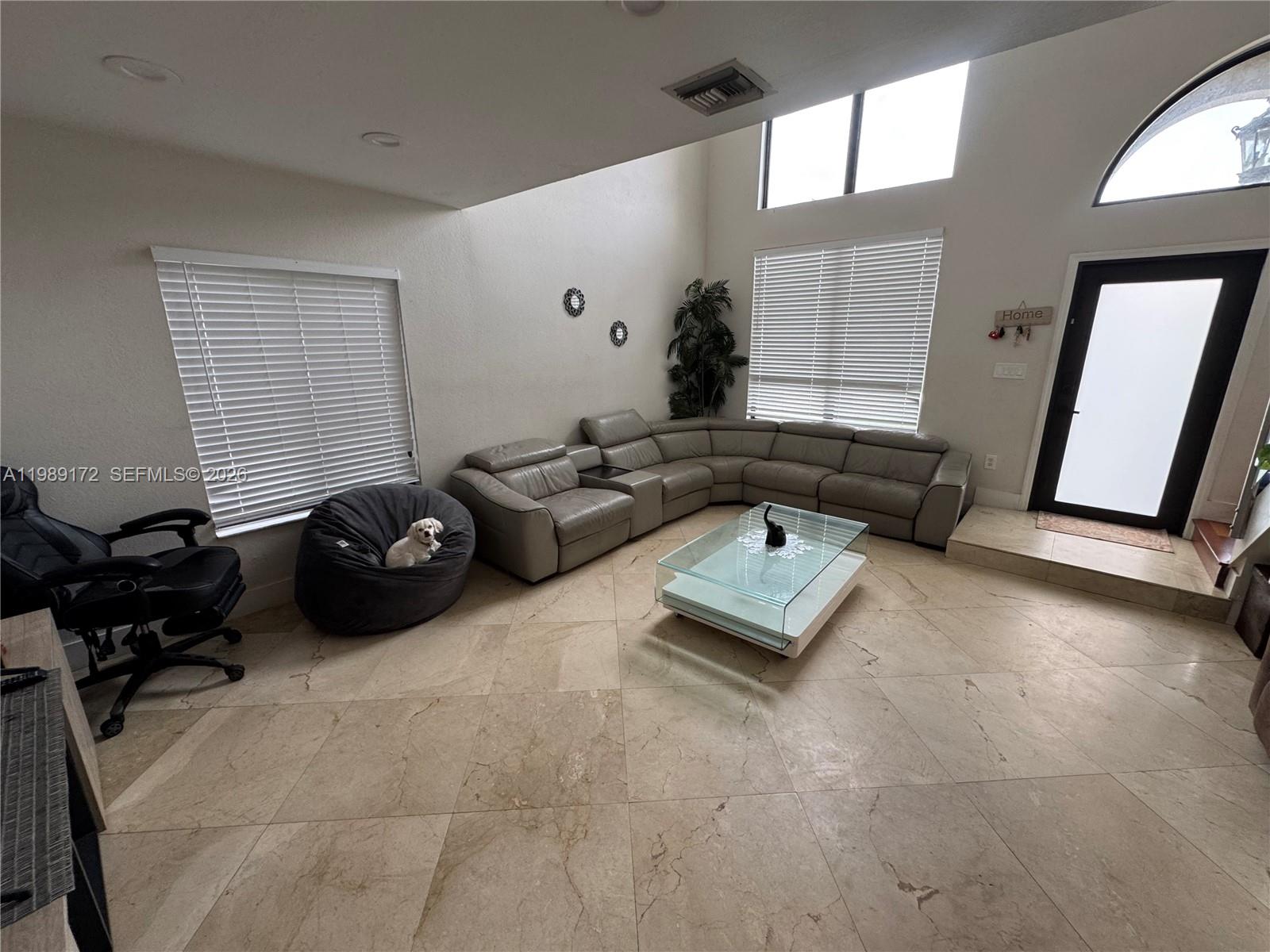 7632 Northwest 166th Terrace Hialeah, FL 33015 - Photo 2 of 20 a living room with furniture and a window